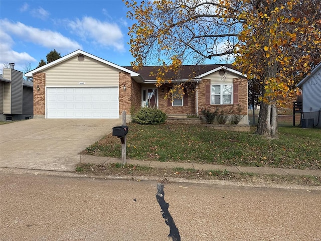 ranch-style home with central AC unit and a garage