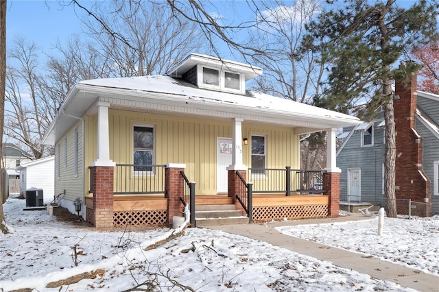 bungalow-style home with cooling unit and a porch