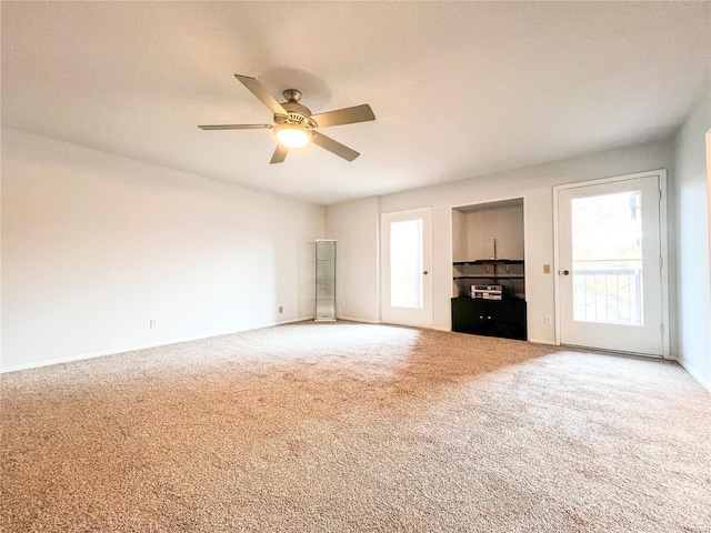 interior space with ceiling fan and carpet floors