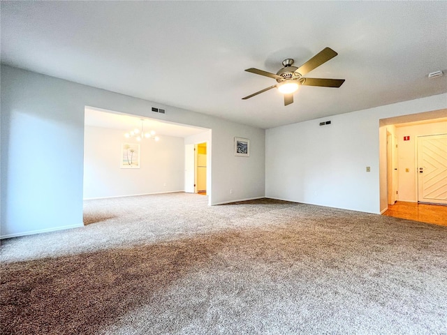 spare room with ceiling fan with notable chandelier and carpet floors