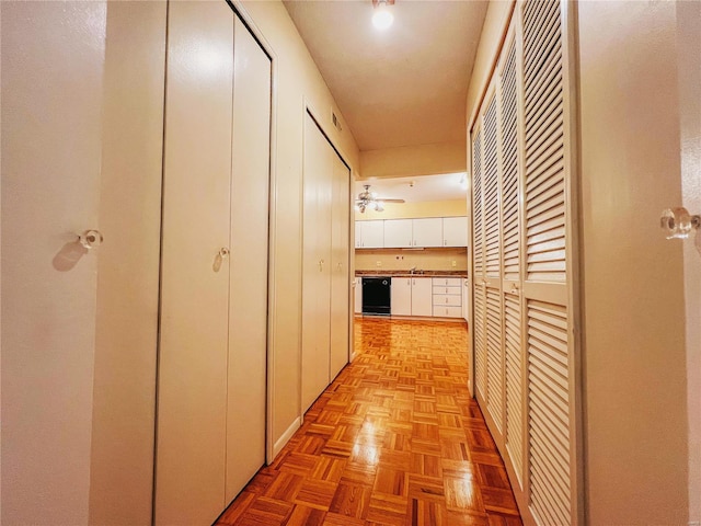 hallway featuring light parquet floors and sink