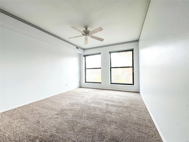 spare room with carpet, ceiling fan, and crown molding