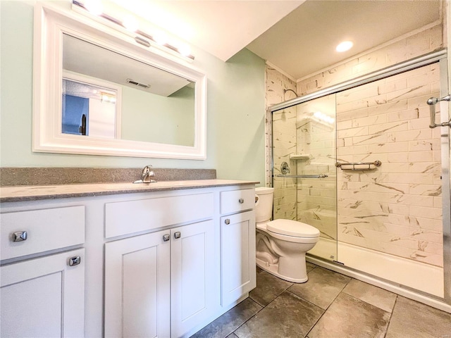 bathroom featuring vanity, toilet, and an enclosed shower