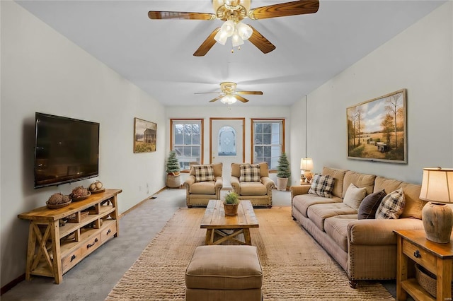 carpeted living room featuring ceiling fan