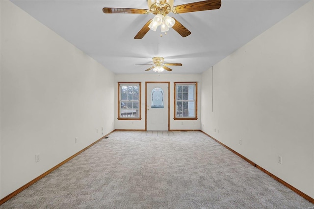 spare room featuring ceiling fan and light carpet