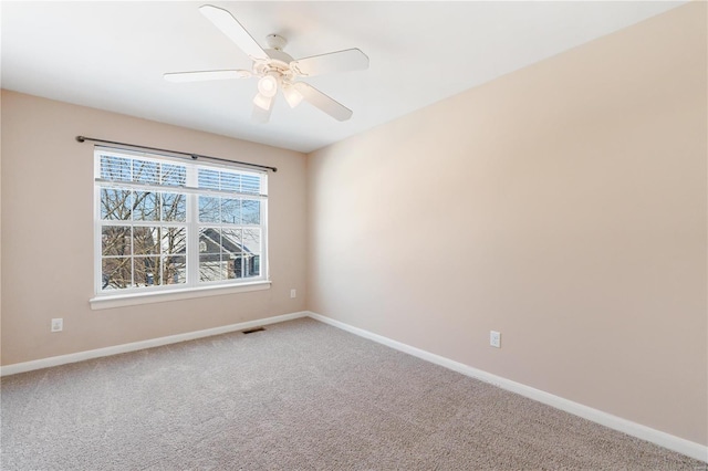 empty room with carpet flooring and ceiling fan