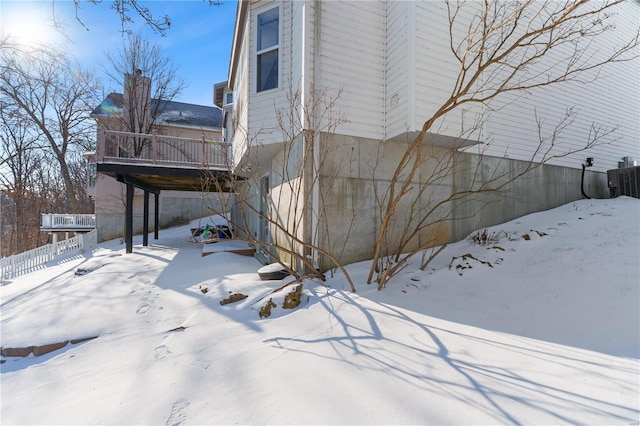 snow covered property featuring a deck