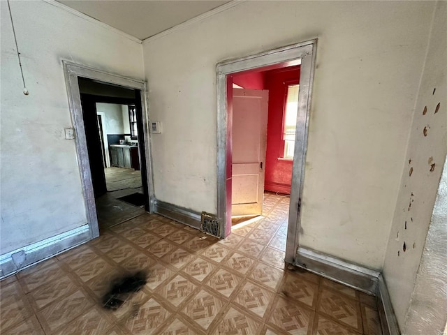 hallway featuring crown molding and parquet flooring