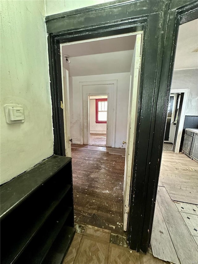 corridor with hardwood / wood-style flooring