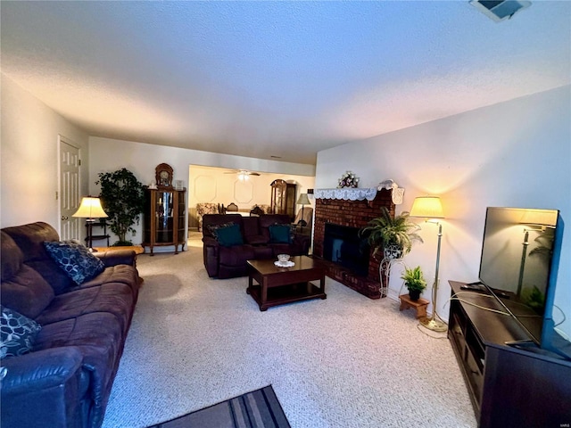 carpeted living room featuring ceiling fan and a brick fireplace