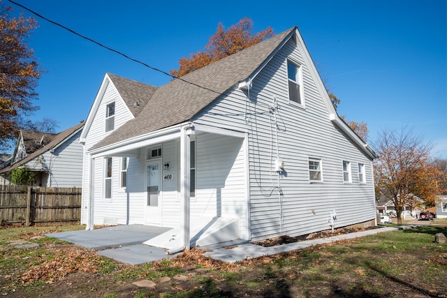 rear view of property with covered porch