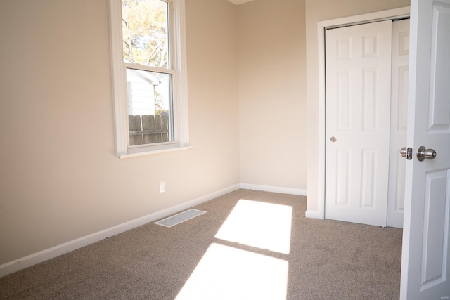 unfurnished bedroom featuring a closet and carpet