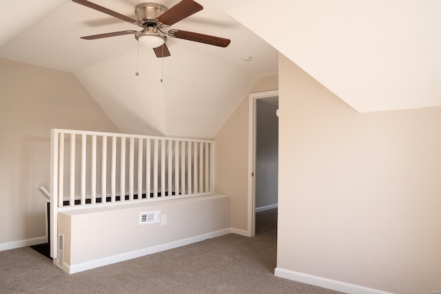 additional living space with ceiling fan, carpet, and vaulted ceiling