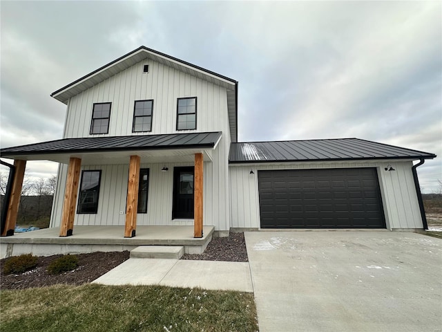 modern farmhouse with a porch and a garage