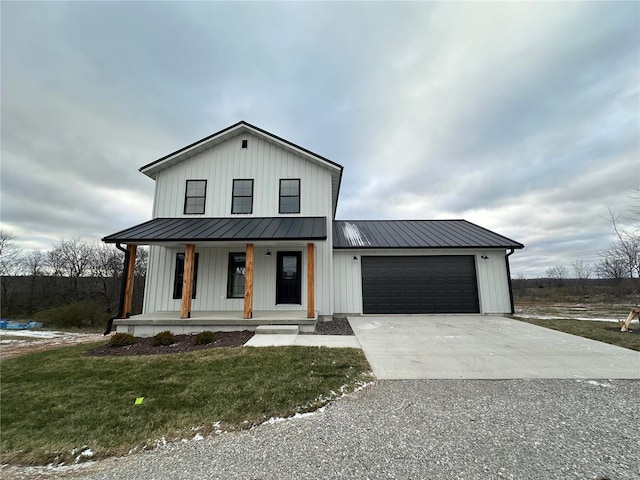 modern farmhouse with a porch, a garage, and a front lawn