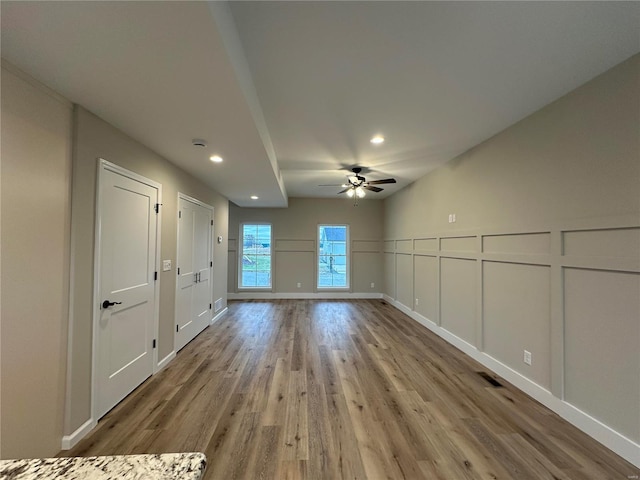 unfurnished living room featuring light hardwood / wood-style floors and ceiling fan