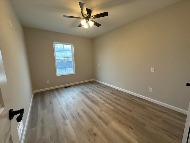 spare room with ceiling fan and light hardwood / wood-style floors