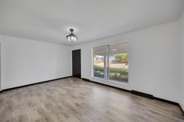 unfurnished room featuring light hardwood / wood-style flooring