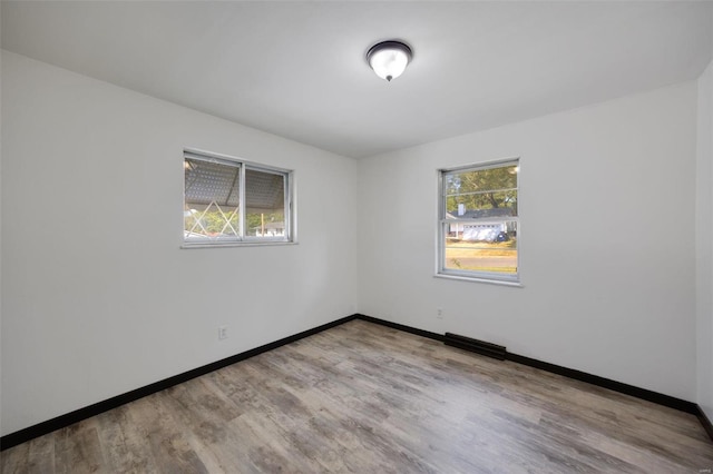 empty room with light hardwood / wood-style flooring