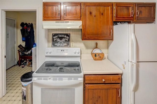 kitchen featuring decorative backsplash, white appliances, and washer / clothes dryer