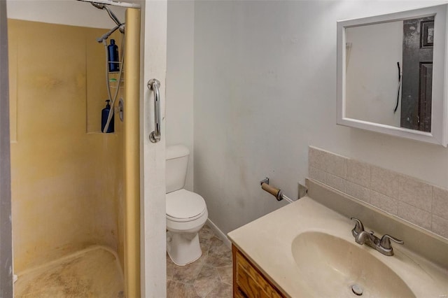 bathroom with a shower, vanity, and toilet