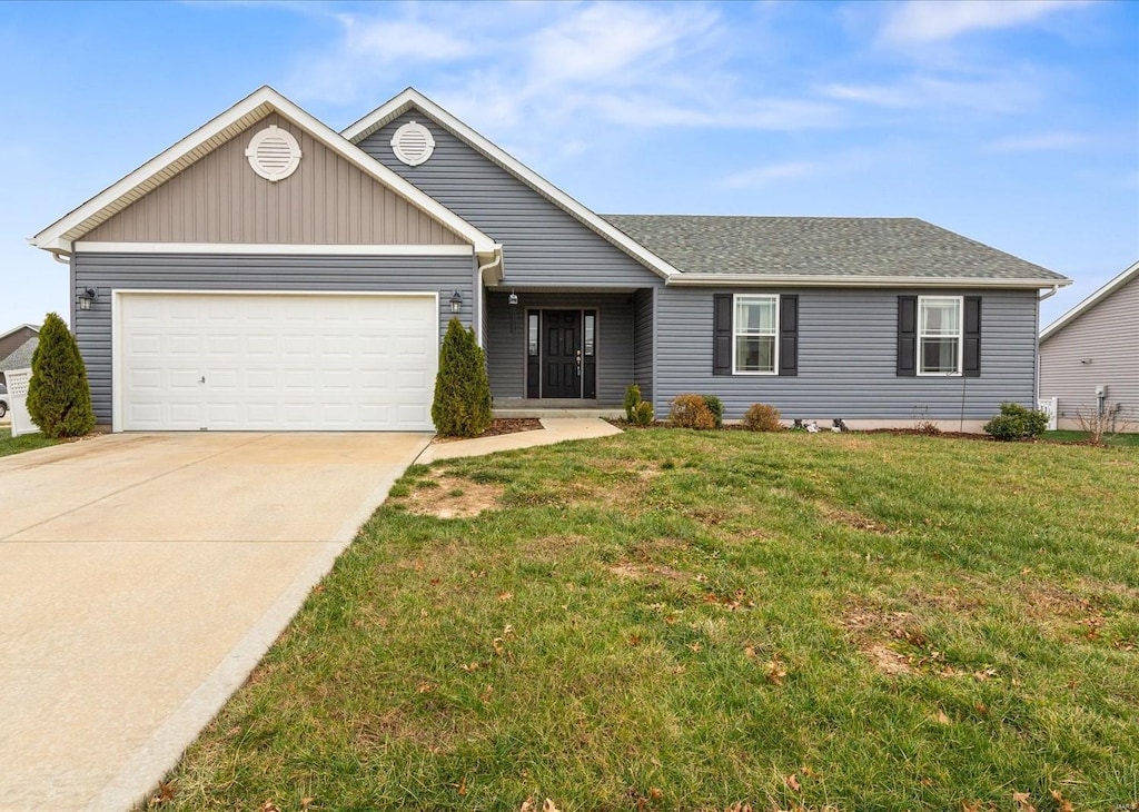 ranch-style home with a garage and a front lawn