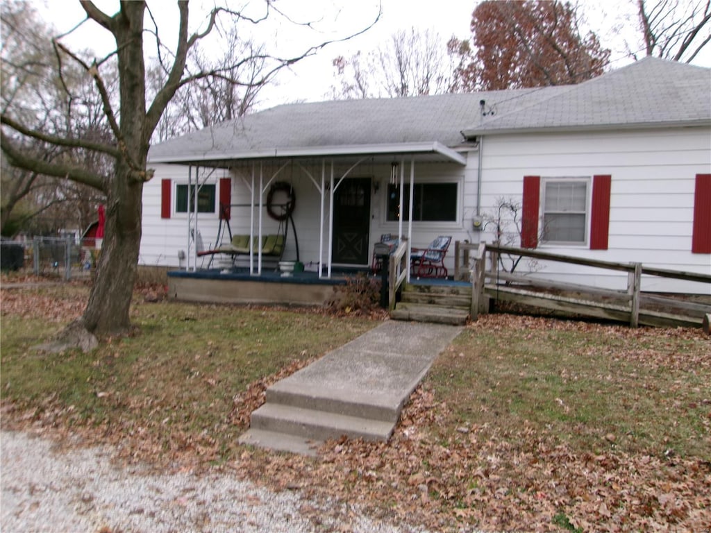 single story home with covered porch and a front lawn