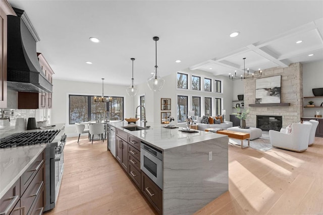 kitchen with hanging light fixtures, light stone counters, an inviting chandelier, and beam ceiling