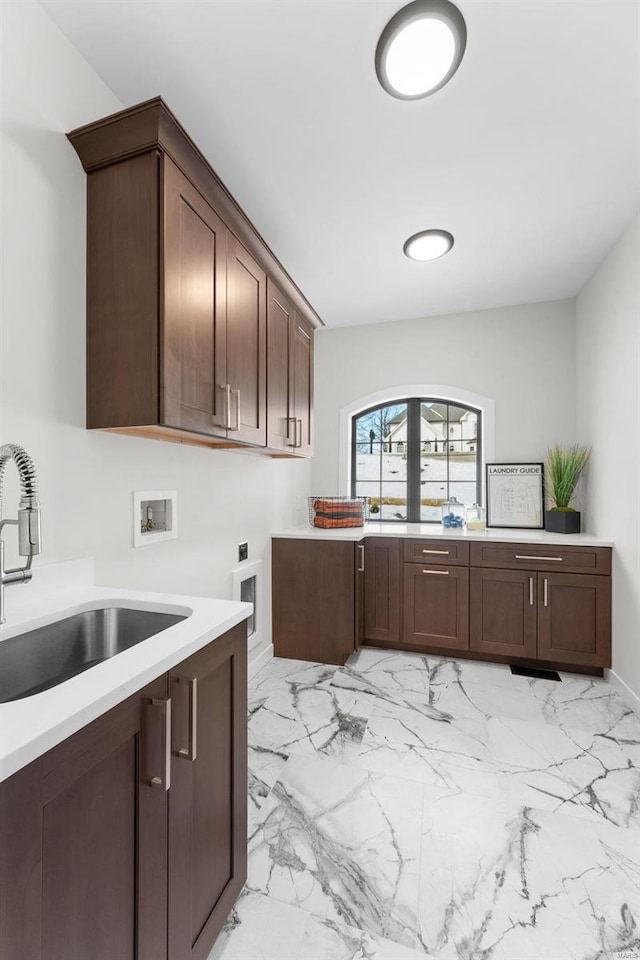 kitchen with dark brown cabinetry and sink