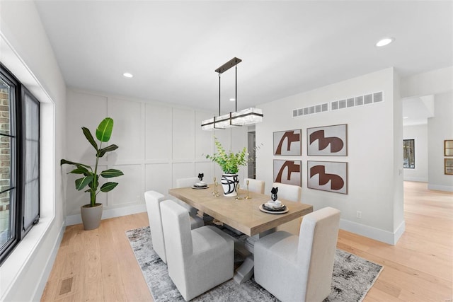 dining room featuring a healthy amount of sunlight and light wood-type flooring