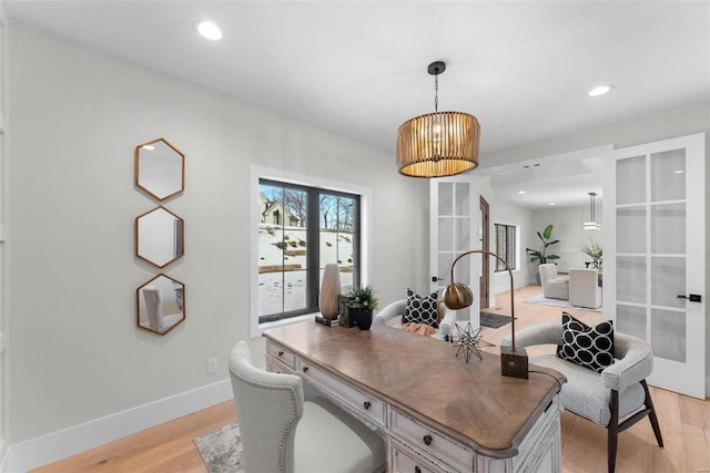 office space with light hardwood / wood-style floors and french doors