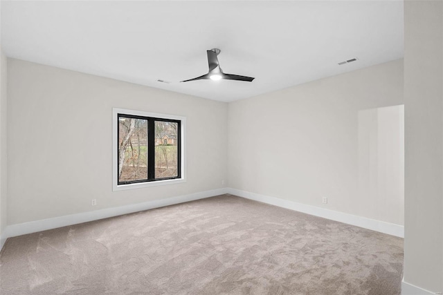 empty room featuring ceiling fan and carpet flooring