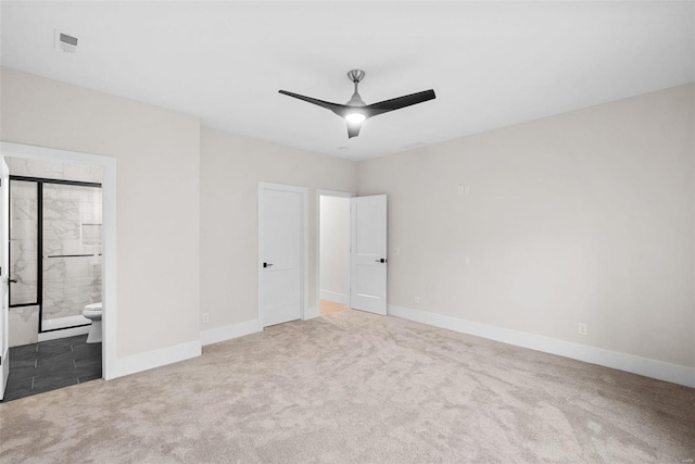 unfurnished bedroom featuring ceiling fan, carpet, and ensuite bath