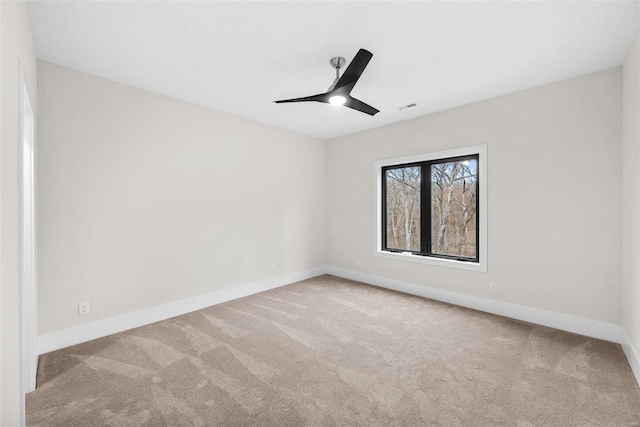 carpeted empty room featuring ceiling fan