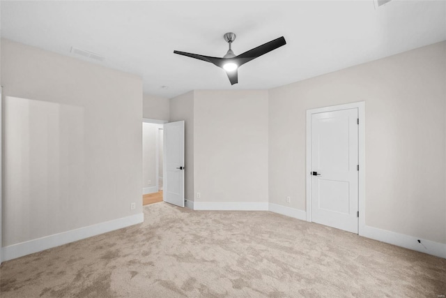 unfurnished room featuring ceiling fan and light colored carpet