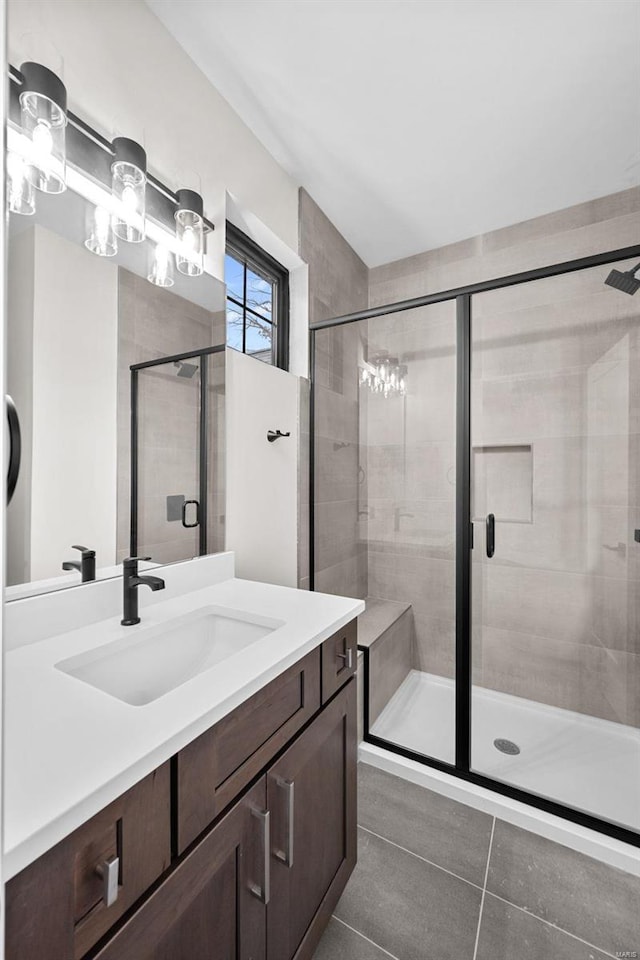 bathroom with vanity, tile patterned floors, and a shower with shower door