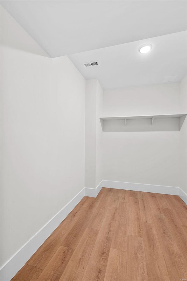 spacious closet with light hardwood / wood-style flooring