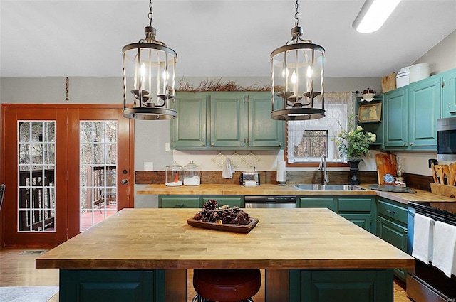 kitchen featuring butcher block countertops, a center island, and sink