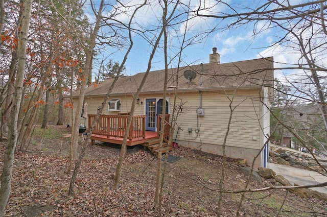 back of property featuring a wooden deck