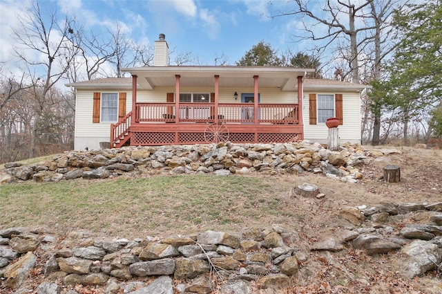 back of house featuring a wooden deck