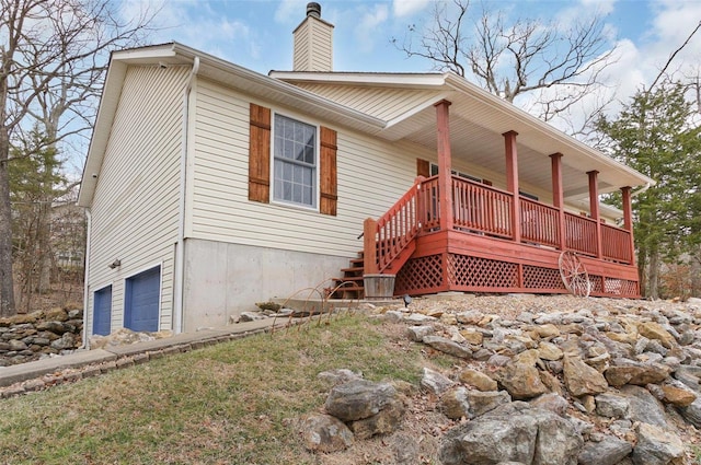 rear view of property with a garage