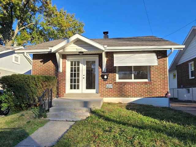 bungalow-style home featuring a front yard