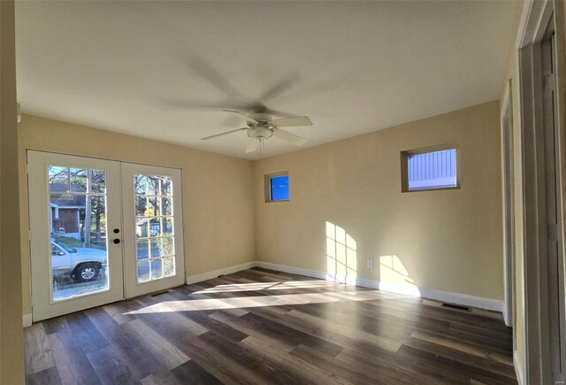 unfurnished room with ceiling fan, french doors, and dark wood-type flooring