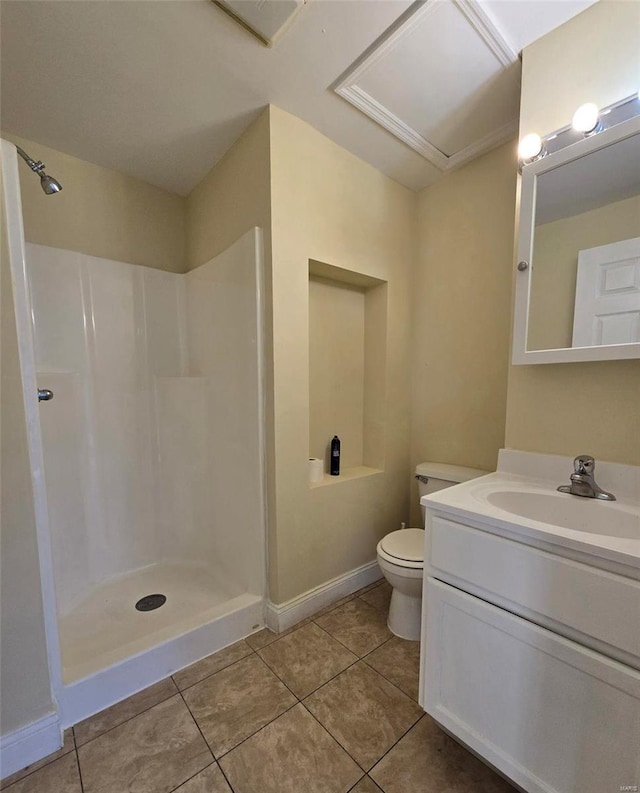 bathroom featuring toilet, vanity, tile patterned floors, and walk in shower