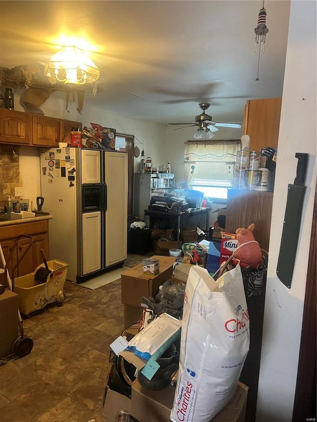 interior space with refrigerator with ice dispenser and ceiling fan