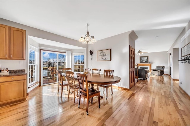 dining space featuring light hardwood / wood-style floors and a chandelier