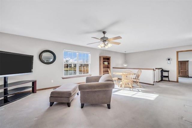 living room featuring ceiling fan and light colored carpet