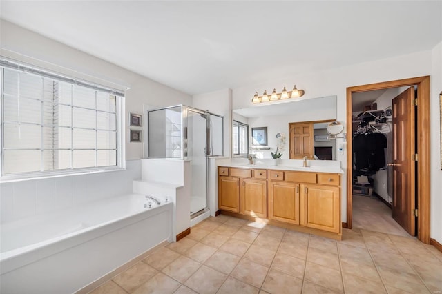 bathroom featuring a wealth of natural light, tile patterned flooring, vanity, and independent shower and bath