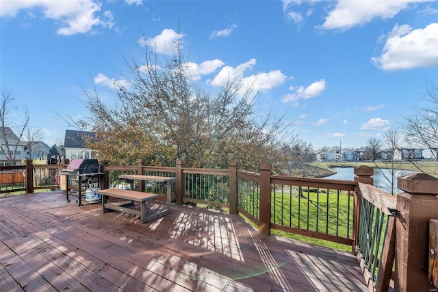 wooden terrace featuring a grill and a water view