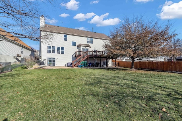 back of house with a deck and a lawn